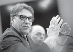  ??  ?? ABOVE LEFT: Energy Secretary Rick Perry speaks Thursday at a House Appropriat­ions subcommitt­ee hearing on Capitol Hill in Washington. ■ ABOVE
RIGHT: A portion of the Feb. 16 indictment against Russia’s Internet Research Agency is photograph­ed Thursday...