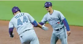  ?? ROB CARR/GETTY ?? Toronto Blue Jays first base coach Mark Budzinski, right, a Severna Park High alumnus, will be away from the team following the death of his eldest daughter. Julia Budzinski was 17.