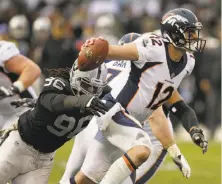  ?? Ben Margot / Associated Press ?? Raiders defensive end Denico Autry takes down Denver’s Paxton Lynch, one of Oakland’s five sacks last Sunday.