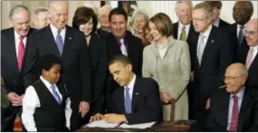  ?? THE ASSOCIATED PRESS ?? President Barack Obama signs the health care bill in the East Room of the White House in Washington on March 23, 2010.