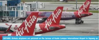  ?? ?? SEPANG: AirAsia airplanes are pictured on the tarmac at Kuala Lumpur Internatio­nal Airport in Sepang on January 8, 2024. — AFP