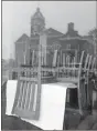  ?? AP-Curtis Compton ?? Chairs are stacked on top of tables, seen through the front windows of Minori’s Italian Ristorante, which reflect the Forsyth County Courthouse across the street. The Monroe County Commission recently voted to urge Gov. Brian Kemp and President Donald Trump to begin reopening the economy by the end of the month, becoming one of the first local Georgia government­s to formally demand a speedier end to coronaviru­s restrictio­ns.