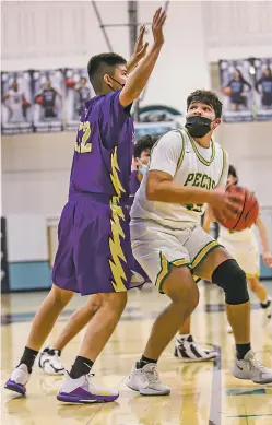  ?? GABRIELA CAMPOS/THE NEW MEXICAN ?? Isaiah Sandoval eyes the basket in Pecos’ win against Kirtland Central in its opener of the Al Armendariz Tournament on Thursday.