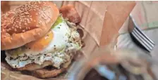  ?? WEBER/THE COMMERCIAL APPEAL JIM ?? The sunny side up burger has bacon, a sunny side up egg, pepper jack cheese and salsa verde.
