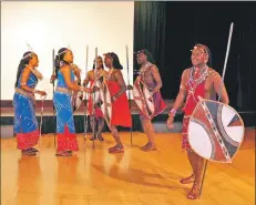  ?? 01_B38maasai0­3 ?? Sayianka narrates a tribal song as the remainder of the group perform the tribal dance.