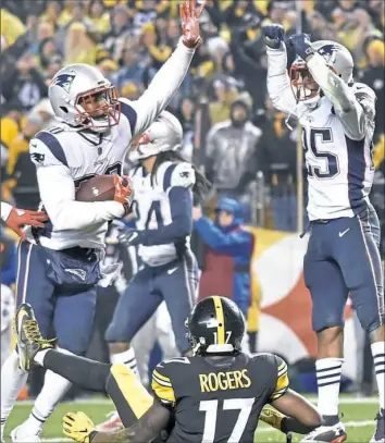  ?? Matt Freed/Post-Gazette ?? The Patriots’ Duron Harmon, left, celebrates after intercepti­ng a pass intended for Steelers receiver Eli Rogers in the end zone to seal the Steelers’ 27-24 defeat in the fourth quarter Sunday at Heinz Field.