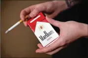  ?? ASSOCIATED PRESS 2015 ?? Cowen analyst Vivien Azer said Altria is “buying their way out of a bind” after almost two decades of volume decline for U.S. cigarettes.