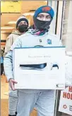  ?? CHRISTOPHE­R DOLAN/AP ?? Ben Hoban carries a new Sony PlayStatio­n 5 out of a GameStop store on Black Friday, in Dickson City, Pennsylvan­ia.