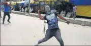  ?? WASEEM ANDRABI /HT FILE ?? A man throws a stone at policemen in Srinagar.