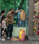  ?? VERNON YUEN / NURPHOTO VIA GETTY IMAGES; PROVIDED TO CHINA DAILY ?? From left: On Qingming, people honor their ancestors and deal with the emotions of losing loved ones; Qingtuan, or green sticky rice balls with sweet fillings are one of the most popular fare.