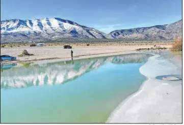  ?? C. Douglas Nielsen ?? Ice can sometimes limit shoreline access to Cold Creek Pond at the north end of the Spring Mountain Range. It offers seasonal trout fishing during cold months.