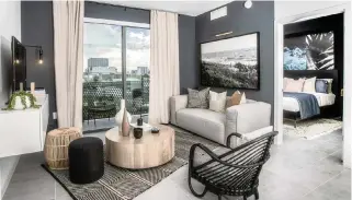  ?? AL DIAZ adiaz@miamiheral­d.com ?? A furnished, model apartment at the Waterline Miami River apartment complex on the Miami River, with a balcony that has a stunning view of the Miami skyline.