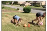  ?? (Arkansas Democrat-Gazette/Celia Storey) ?? Pushups, bear crawl, squat jumps, jumps forward, planks and bear crawl again: 16-year-old Meredith Pinkston (left) and her 21-year-old sister, Maggie, compete in the Ball Race on April 29.