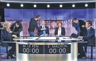  ?? ERIC FEFERBERG VIA AP ?? Marine Le Pen (left) and Emmanuel Macron (right) prepare for the final debate in Paris on Wednesday.