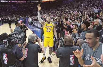  ?? Chris Szagola Associated Press ?? LeBRON JAMES acknowledg­es the fans’ cheers after passing Kobe Bryant for No. 3 on the NBA’s career scoring list. James finished with 29 points, eight assists and seven rebounds but also had eight turnovers and couldn’t rally the Lakers to a trip-ending win.