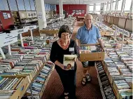  ?? WARWICK SMITH/STUFF ?? Shop manager Beverley Keenan and president Red Cross Manawatu¯ branch Don Thomas restock the tables with more books.