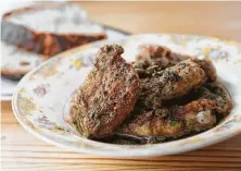  ?? Elizabeth Conley / Houston Chronicle ?? Rabbit “wings,” legs coated in a glaze of brown butter, capers and lemon. are elemental and delicious.