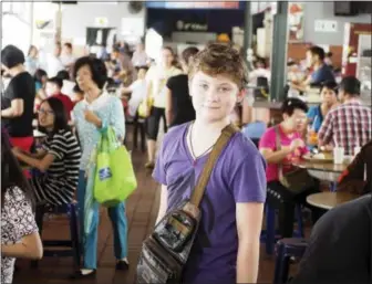  ?? TED ANTHONY — THE ASSOCIATED PRESS ?? This photo shows Mason Anthony at a hawker center in Penang, Malaysia. Anthony occasional­ly travels alone with his mother or father. Although family vacations are valuable for building a sense of family identity, solo trips for one child with one...