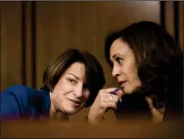  ?? Washington Post photo by Melina Mara ?? Senators Amy Klobuchar, D-Minn., and Kamala Harris, D-Calif., speak quietly during a congressio­nal hearing.