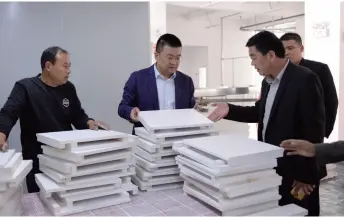  ??  ?? Yang Fan, head of Shaji Town in Suining County of Jiangsu Province, learns about business performanc­e at a factory on October 16, 2018