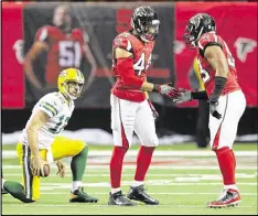  ?? CURTIS COMPTON / CCOMPTON@AJC.COM ?? Vic Beasley (center, congratula­ted by Dwight Freeney after dropping the Packers’ Aaron Rodgers) has 15.5 sacks this season.