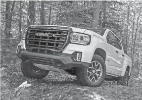  ?? GMC ?? The 2021 GMC Canyon AT4 midsize pickup has a black chrome grille and skid plate to protect its transfer case.