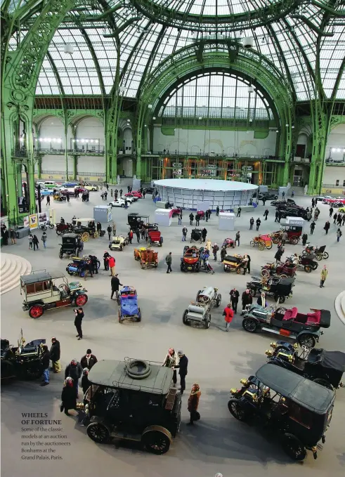  ??  ?? WHEELS OF FORTUNE Some of the classic models at an auction run by the auctioneer­s Bonhams at the Grand Palais, Paris.