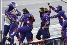  ?? MATT SLOCUM — THE ASSOCIATED PRESS ?? Crew members for Denny Hamlin celebrate Hamlin’s win in the NASCAR Cup Series auto race at Pocono Raceway, Sunday in Long Pond, Pa.