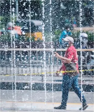  ??  ?? A MAN walks past the rehabilita­ted water fountain fronting the Liwasang Bonifacio, one of the more recent feel good projects of the sitting Manila mayor Isko Moreno.