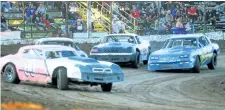  ??  ?? St. Catharines driver James Thompson, No. 00, leads the field into Turn 1 in a Hoosier Stock heat at Merrittvil­le Speedway Saturday night in Thorold. He went on to win the feature, his first of the season.