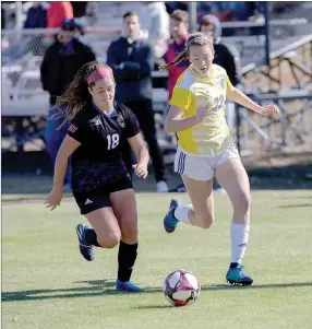  ?? Photo courtesy of JBU Sports Informatio­n ?? John Brown’s Jenna Miller, right, runs with Southweste­rn Christian’s Anne Marie Favarola during last Saturday’s game at Alumni Field. JBU and SWC played to a 1-1 draw after two extra time periods.