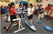  ?? Melissa Phillip / Houston Chronicle ?? Third-graders at Best Elementary in Alief ISD work in a lab dedicated to so-called kinestheti­c furniture.