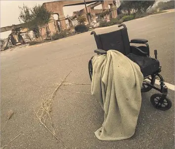  ?? Brian van der Brug Los Angeles Times ?? A WHEELCHAIR is abandoned near the evacuated Villa Capri assisted-living facility on Monday in Santa Rosa. Health providers across the region are seeing resources and staff stretched thin as the fires rage on.