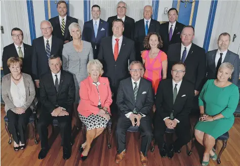  ?? TROY FLEECE ?? Lt.-Gov. Vaughn Solomon Schofield, front row, third from left, Saskatchew­an Premier Brad Wall, fourth from left front row, and his newly appointed provincial cabinet gather at Government House on Tuesday. The 17-member cabinet is one fewer than its...