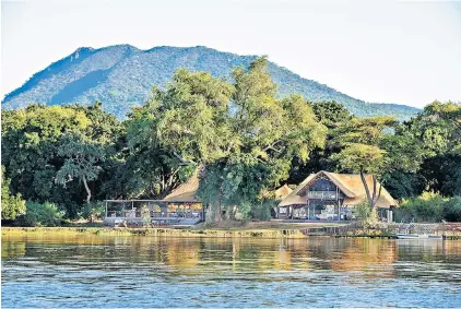  ?? Simon Parker on the Zambezi River ?? Go with the flow: Chiawa Camp offers guests an escape from their busy schedules
