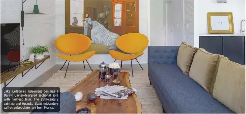  ??  ?? Jake Lefebure’s basement den has a Darryl Carter-designed sectional sofa with nailhead trim. The 19th-century painting and Augusto Bozzi midcentury saffron velvet chairs are from France.