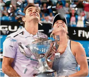  ??  ?? On cloud nine: Roger Federer and Belinda Bencic of Switzerlan­d hoisting the Hopman Cup after defeating Alexander Zverev and Angelique Kerber of Germany in the Hopman Cup yesterday. — AFP