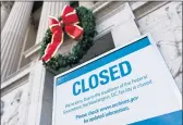  ?? ANDREW CABALLERO-REYNOLDS/GETTY-AFP ?? A sign is displayed Saturday at the National Archives, which is closed because of a government shutdown.