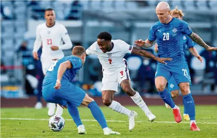  ??  ?? That’s mine: England’s Raheem Sterling (centre) in action against Iceland players during the Nations League match in Reykjavik. — Reuters