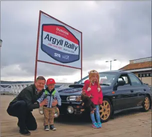  ??  ?? Campbell Lauffer proud owner of a limited edtition Colin McRae Subaru Impreza is pictured with Torin Colliier and his daughter Katy Lauffer.