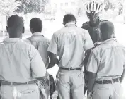  ??  ?? In this 2013 photo, a police, from the bicycle patrol team, searches a group of schoolboys who was seen loitering in the St William Grant Park in downtown Kingston.