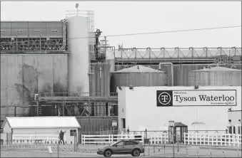  ?? [CHARLIE NEIBERGALL/ THE ASSOCIATED PRESS] ?? A worker leaves the Tyson Foods plant, Friday, in Waterloo, Iowa.