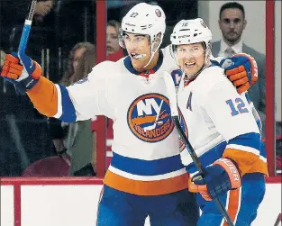  ??  ?? 1-FOR-1: Josh Bailey (right) celebrates his OT game-winner with Anders Lee in Raleigh on Thursday night as the Isles opened the season with a 2-1 win over Carolina.