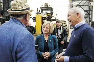  ?? JASON FRANSON/THE CANADIAN PRESS ?? Fort McKay Chief Jim Boucher, Premier Rachel Notley and Suncor CEO Steve Williams gather during the Suncor Fort Hills grand opening in Fort McMurray on Monday.