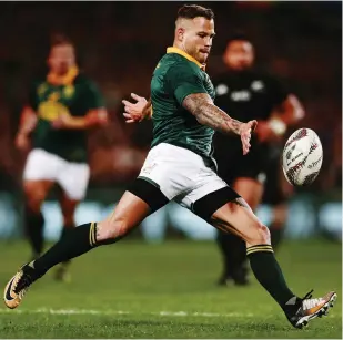  ?? Picture: GETTY IMAGES/ANTHONY AU-YEUNG ?? A MARKED MAN: Springboks’ Francois Hougaard puts in a kick during the Rugby Championsh­ip match against the All Blacks in Auckland. Hougaard will be one of the players who will have to cover up their tattoos.