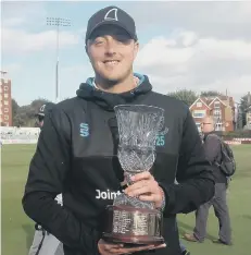  ??  ?? Ollie Robinson with Sussex’s four-day player-of-the-year trophy last year