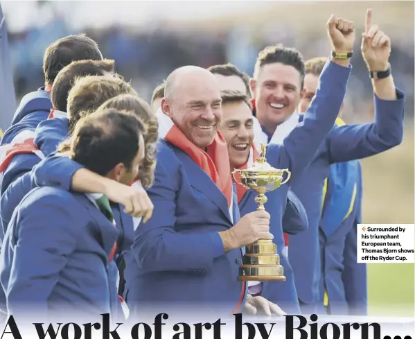  ??  ?? 2 Surrounded by his triumphant European team, Thomas Bjorn shows off the Ryder Cup.