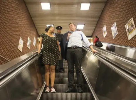  ?? EDUARDO LIMA/METRO ?? Mayor John Tory rode the Bloor line subway Wednesday in a car without working air conditioni­ng after Bianca Spence, left, challenged him on Twitter.