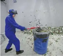  ?? Reuters ?? A student, wearing protective gear, smashes a computer keyboard in an anger room in Beijing on Saturday.