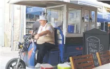  ?? ?? A street vendor rides his mobile shop in the Turkish-controlled side of the divided Cypriot capital Nicosia.